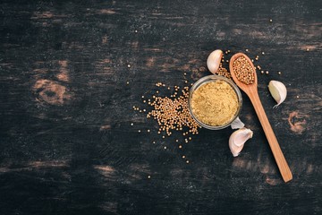 Dry Mustard Grain. Spices On a wooden background. Top view. Copy space for your text.