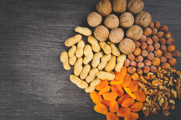  Nuts lie in a circle on a gray table for a healthy lifestyle