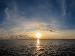 Blue sea and blue sky with white cloud and sunrise up from sea in gulf of Thailand.