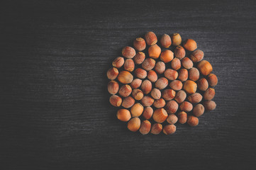  Nuts lie in a circle on a gray table for a healthy lifestyle