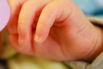 Little newborn baby hand closeup