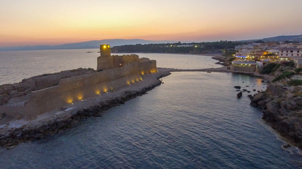 Sunset aerial view of Aragonese Fortress, Calabria - Italy