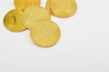 Gold Bitcoins on white background. Selective focus..