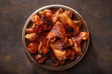 Barbecued chicken wings in the bbq sauce on the plate. - 197516526