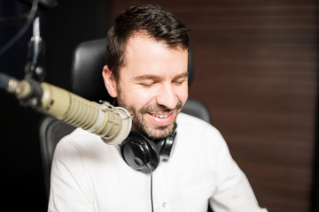 Male broadcaster at radio station