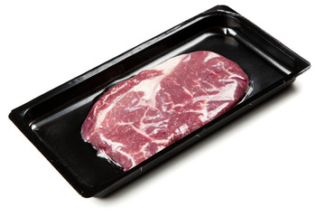Raw steak in an airtight packaging