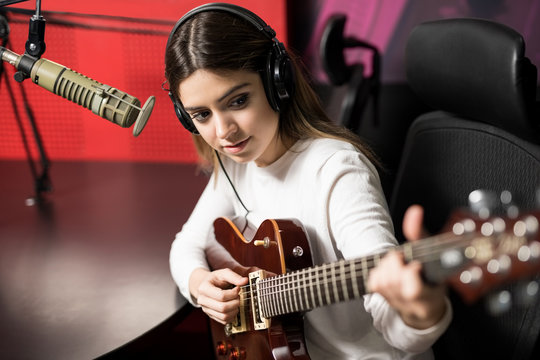 Female singer playing music in radio station