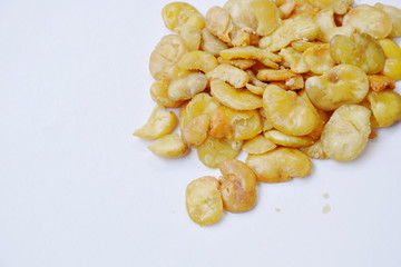 baked salt broad beans on white background