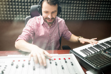 Sound engineer composing music in recording studio