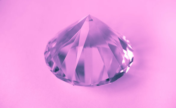 Pink shiny brilliant gemstone crystal. Violet jewelry diamond isolated on a white background.