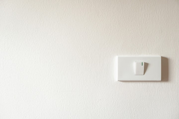 light switch on white concrete wall