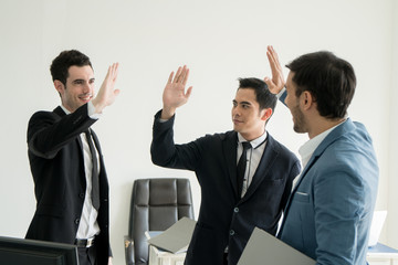 Business men giving High Five as celebration for success deal. Concept for Work, Meeting,...
