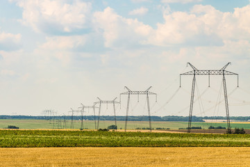 Air line supports. Intermediate steel overhead transmission line supports. Industrial countryside...