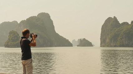 Photographer photographing the nature of Ha Long Bay.