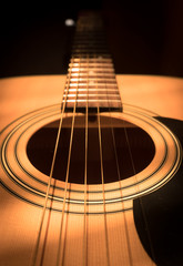 Obraz premium acoustic guitar with a hand in the Sun