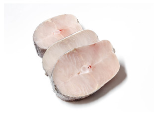 Pieces of fresh raw hake fish isolated on white background.
