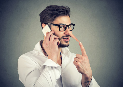Man speaking on phone and lying