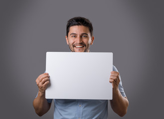 Youn man holds board