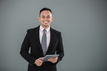 Young adult businessman with tablet