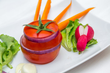 tomato with onion, carrot, curry and radishes on white background