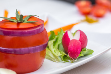 tomato with onion, carrot, curry and radishes on white background