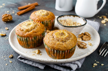 Banana muffins with cinnamon on a concrete background
