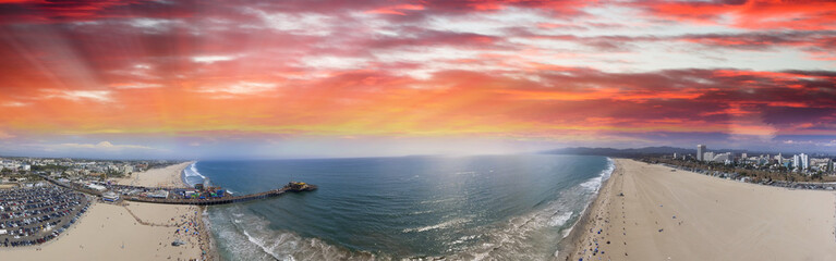 Fototapeta premium Aerial panoramic view of Santa Monica coastline and pier at dusk, CA