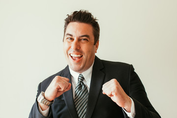 Cheerful businessman standing in boxing stance