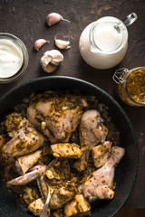 Fried pieces of chicken in a frying pan view from above. Indian food