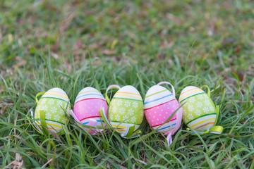 Soft Focus Easter Eggs in Meadow Against Blurred Grass Background