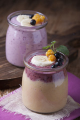  Smoothies with cloudberries, a banana and a blueberry