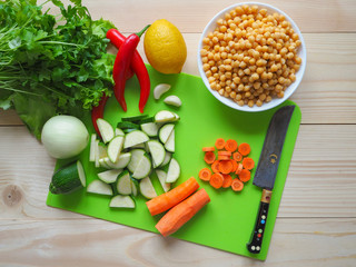 Vegetables cut. Chickpeas with zucchini. Vegetarian diet. Rustic useful kitchen.