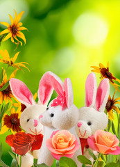 toy hares and flowers in the garden