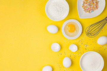  concept of the Easter bakery, various products for home baking, sugar, eggs and flour, coconut munt, top view, empty space for text on a yellow background in the style of pop art mocap layout