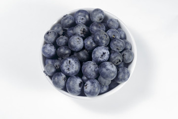 Blueberry in a white dish on a white background, Ready to Eat, Vegan food.