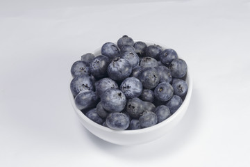 Blueberry in a white dish on a white background, Ready to Eat, Vegan food.