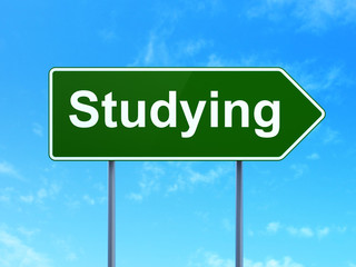 Studying concept: Studying on green road highway sign, clear blue sky background, 3D rendering