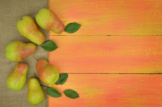 Fresh organic pears on bright wooden background . Fruit background. Pear autumn harvest.