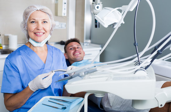 Female dentist with male patient in chair