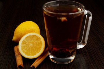 tea with lemon and cinnamon on a wooden table