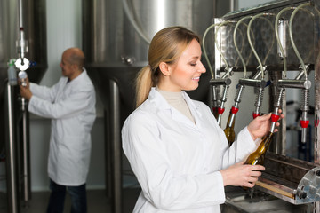 Woman working on modern brewery.