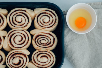 Cinnamon rolls or cinnabon handmade raw dough preparation with spices. Sweet Homemade Pastry christmas baking. Kanelbule - swedish dessert. Top view.