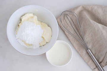Preparation of the dough. The rolled out dough with the ingredients - flour, eggs,  and cooking instruments . On a white wooden background. Top view