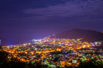 A picturesque panorama of the night city from the top of the mountain.