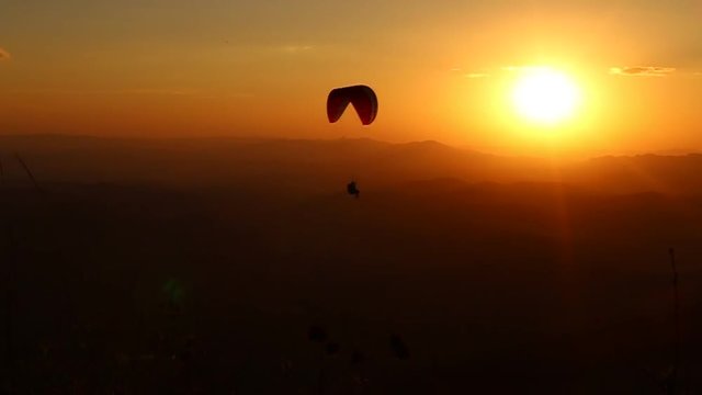 paragliding with beautiful sunset background