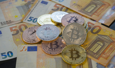Euros and Bitcoin BTC coins on bills of euro banknotes. Worldwide virtual internet cryptocurrency and digital payment system. Digital coin crypto money on bitcoin farm in digital cyberspace
