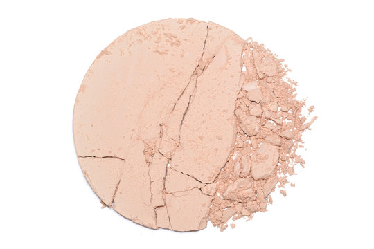 A sample of face powder in white. Beige round cracked powder palette. Decorative cosmetic product