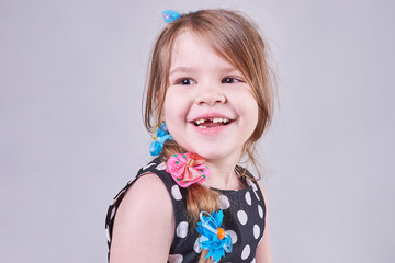 Beautiful little girl smiles a toothless smile