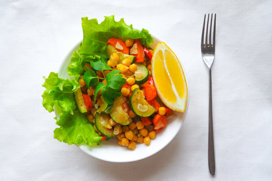 Warm vegetable salad with chickpeas and zucchini. Lean vegetarian cuisine.
