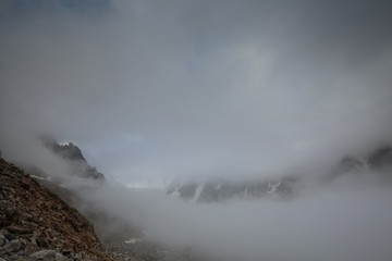 Movement of clouds and water flows in a stormy river in the Caucasus mountains in summer